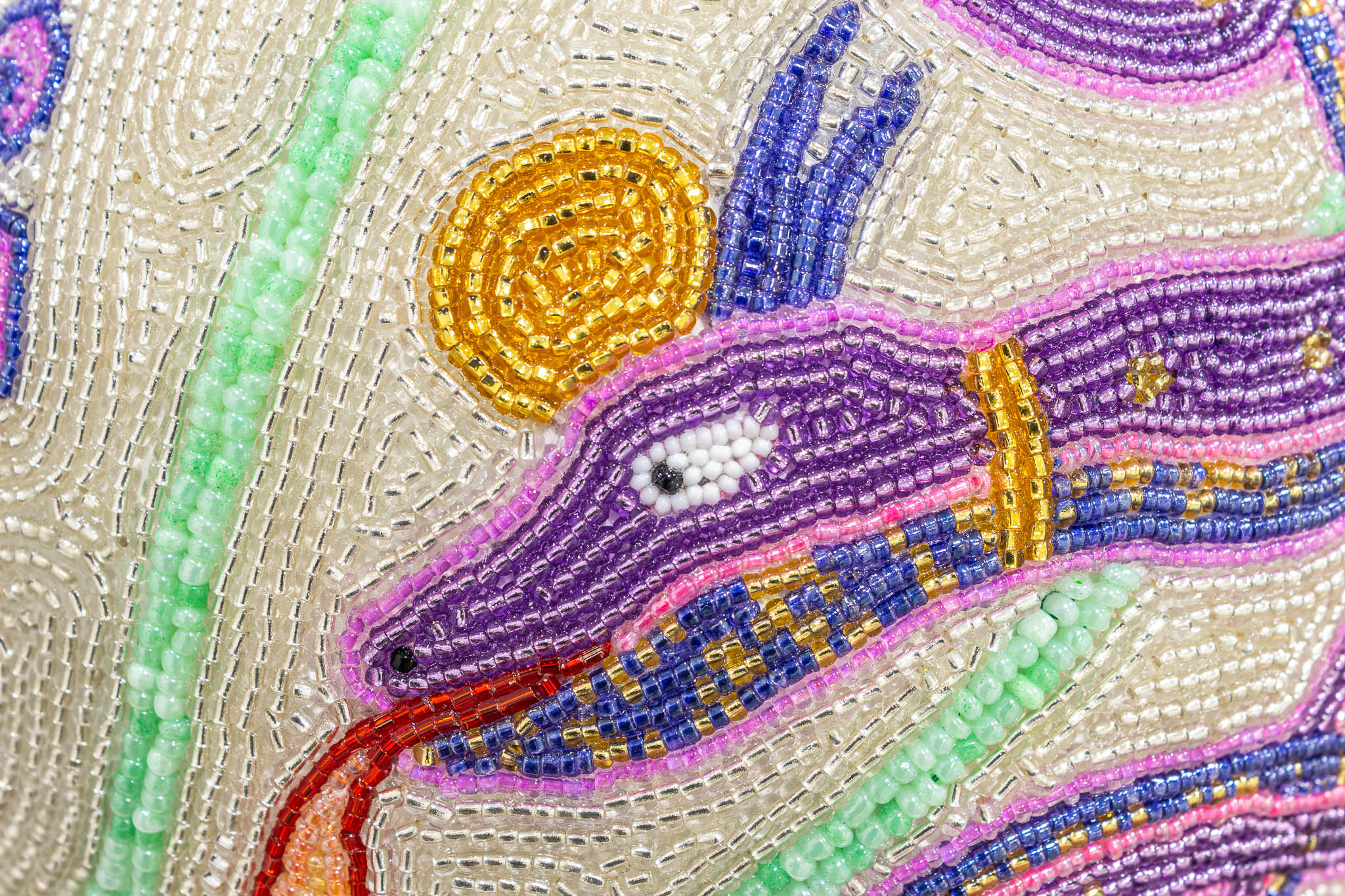 a detail of a purple beaded snake