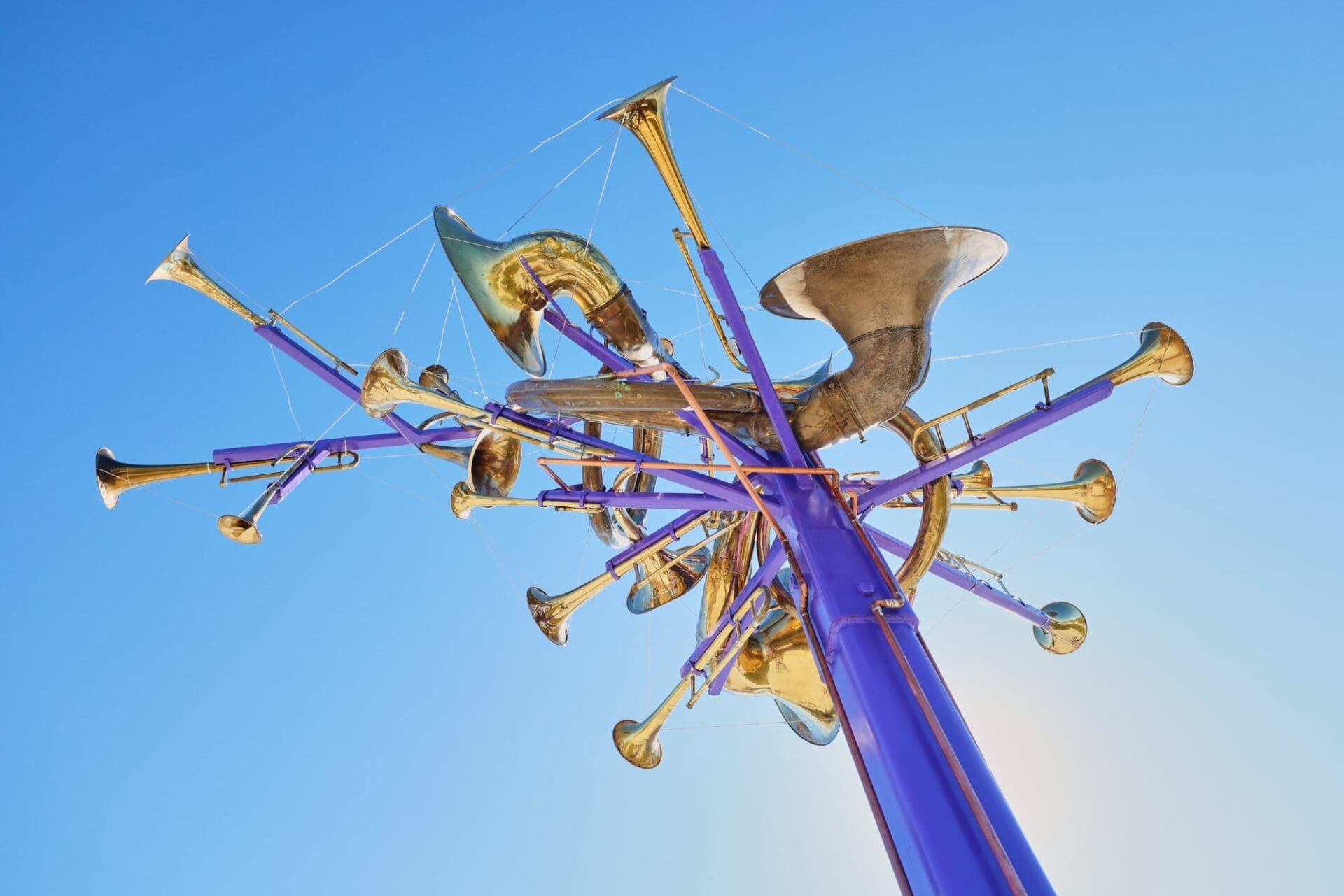 a cluster of brass instruments atop a large purple pole