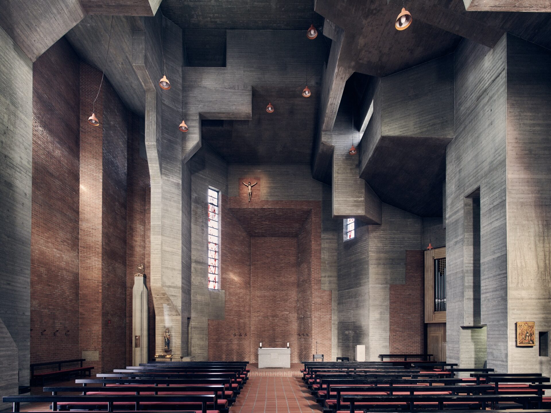 an interior overview of a large brutalist church with angular concrete walls, soft light, and wooden pews