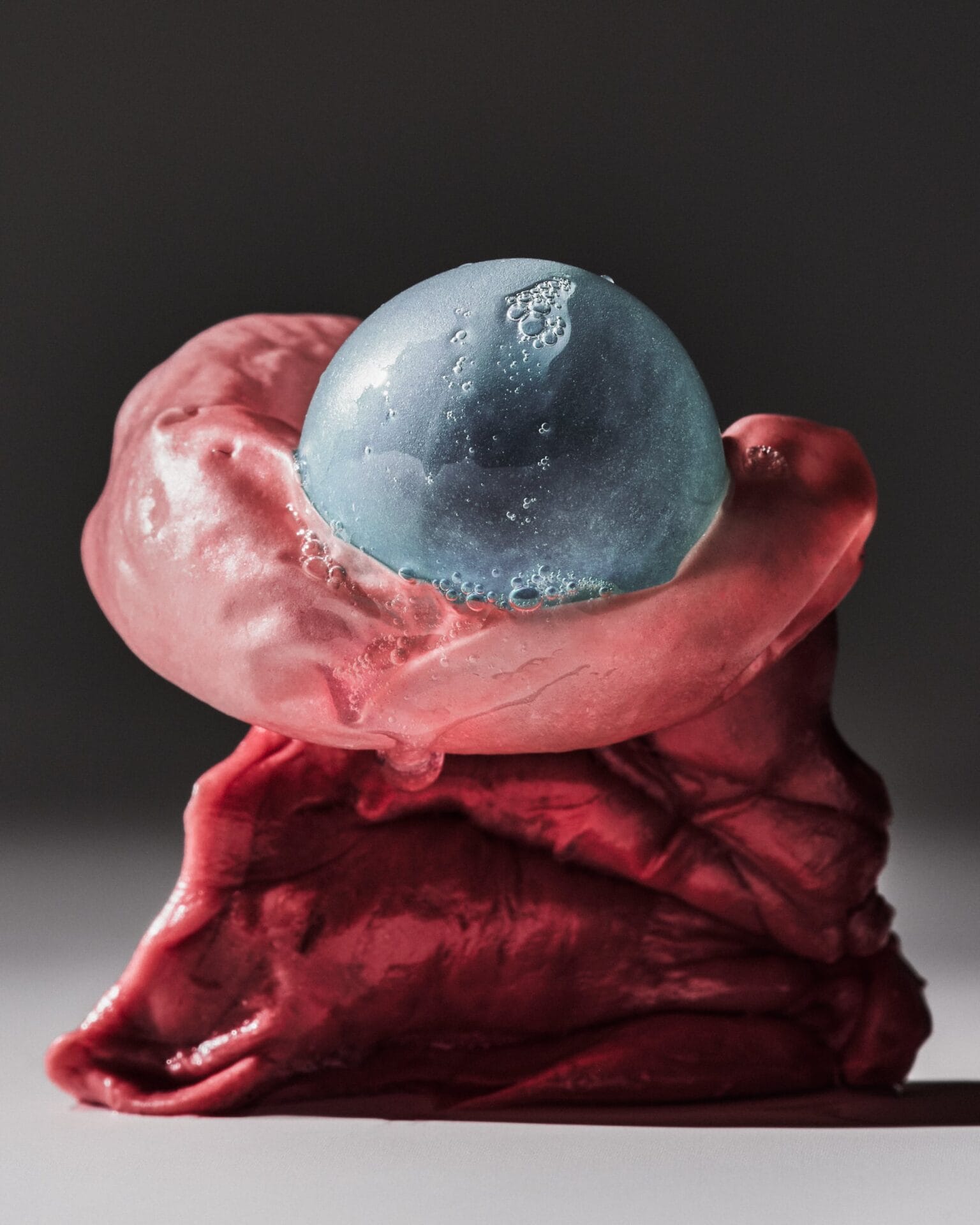 a photo of blown bubblegum with a blue bubble at the top 