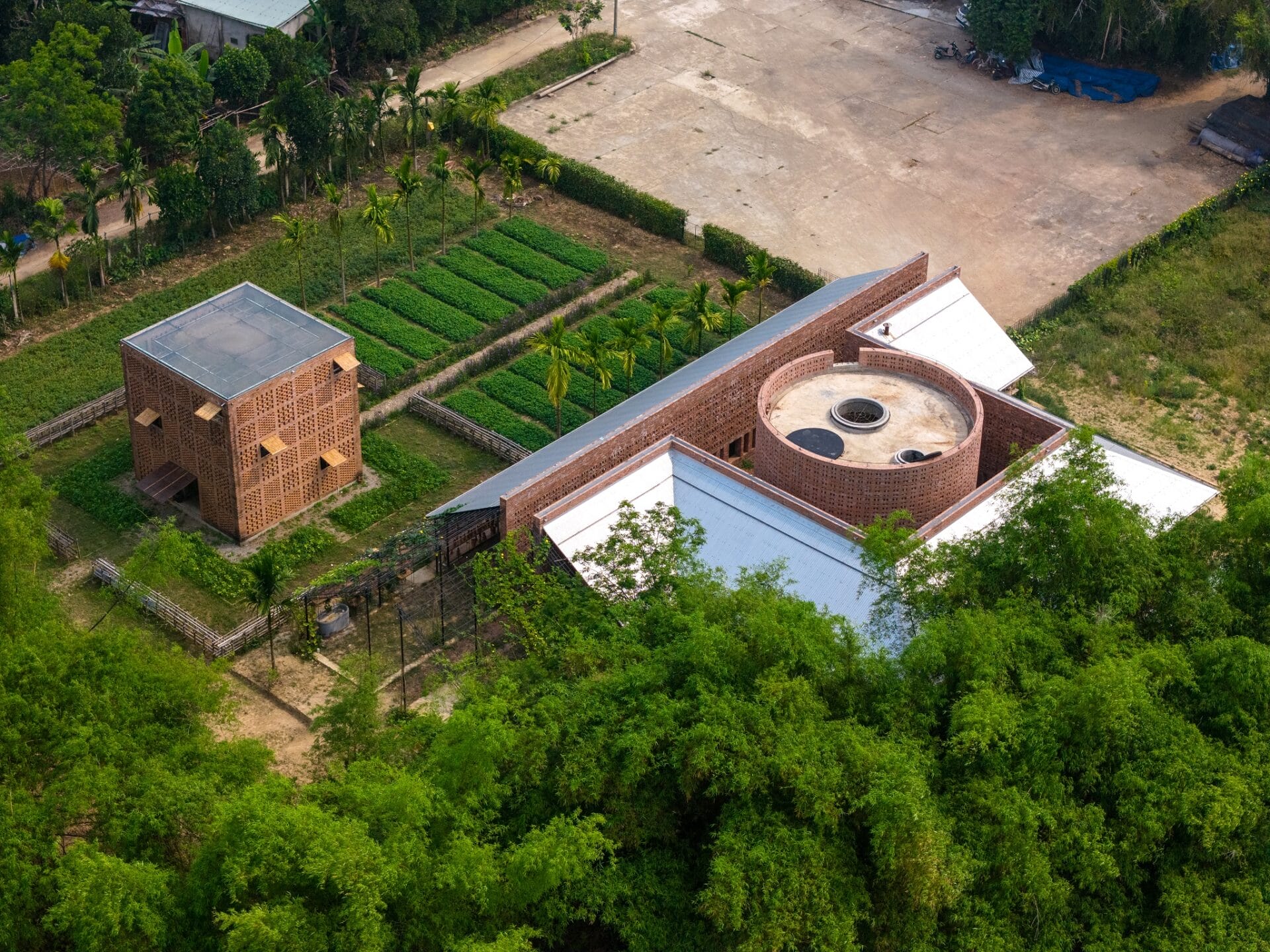 an aerial view of a terra cotta workshop and studio in Vietnam surrounded by greenery