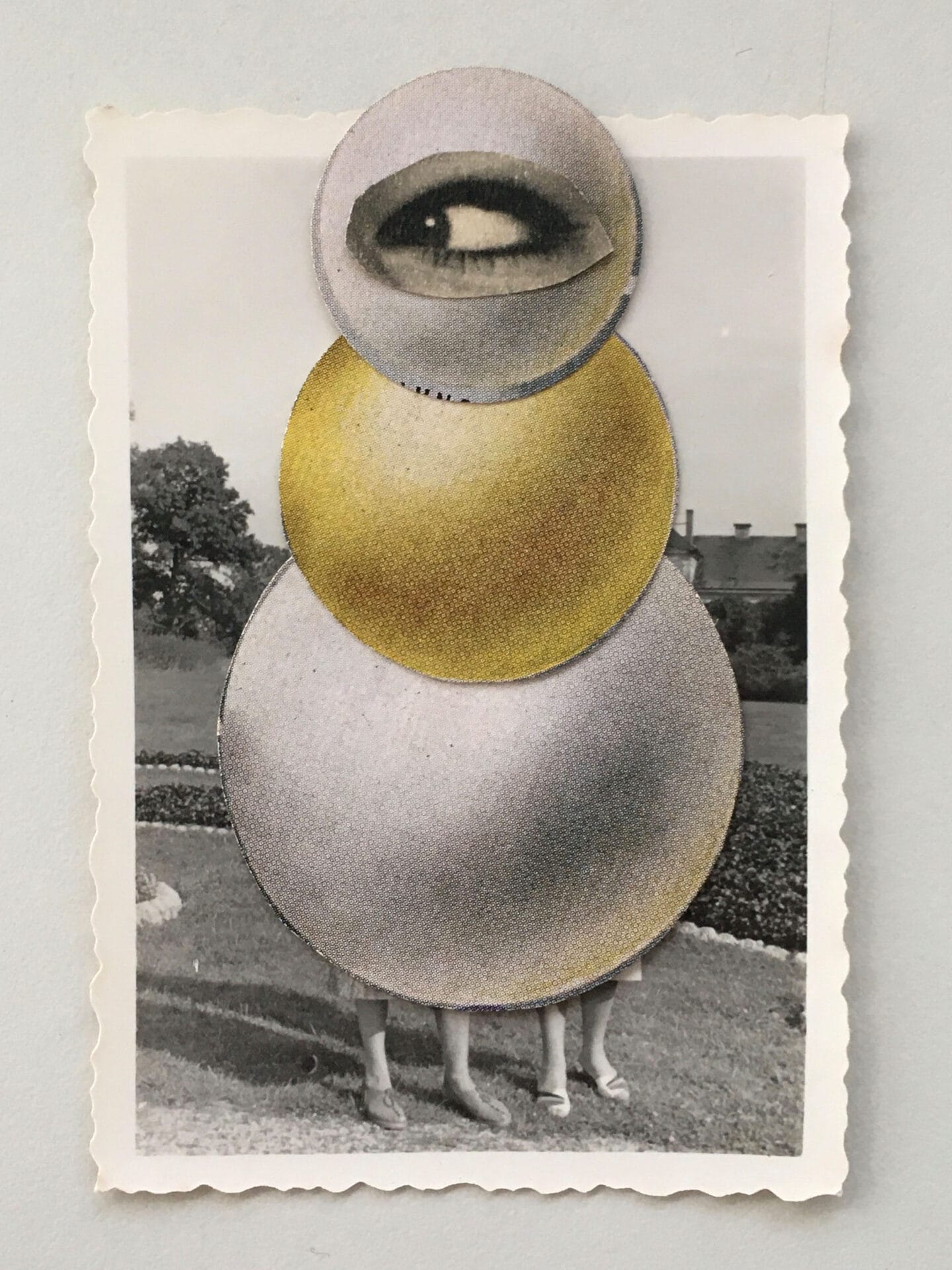 vintage papers collaged into the shape of a bulbous figure with one large eye