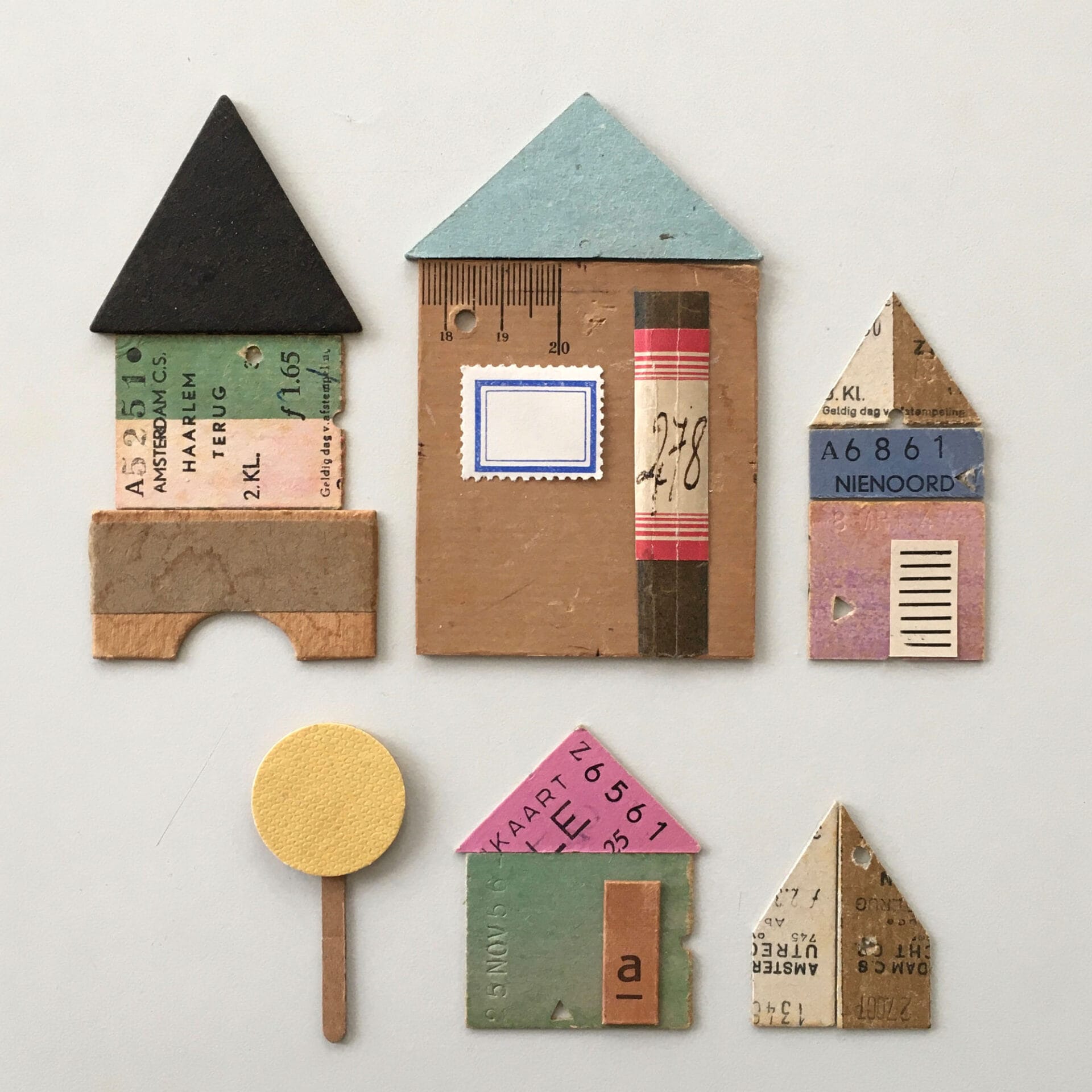 vintage papers collaged into the shape of buildings and a road sign