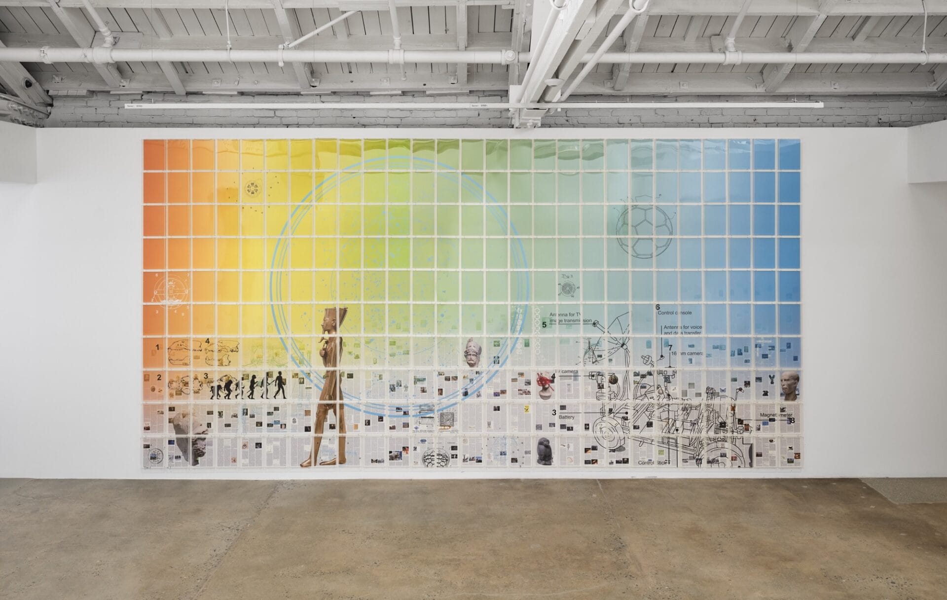 a colorful wall installation showing a prismatic gradient and a grid of rectangles with a sweeping scene of figures and landscape