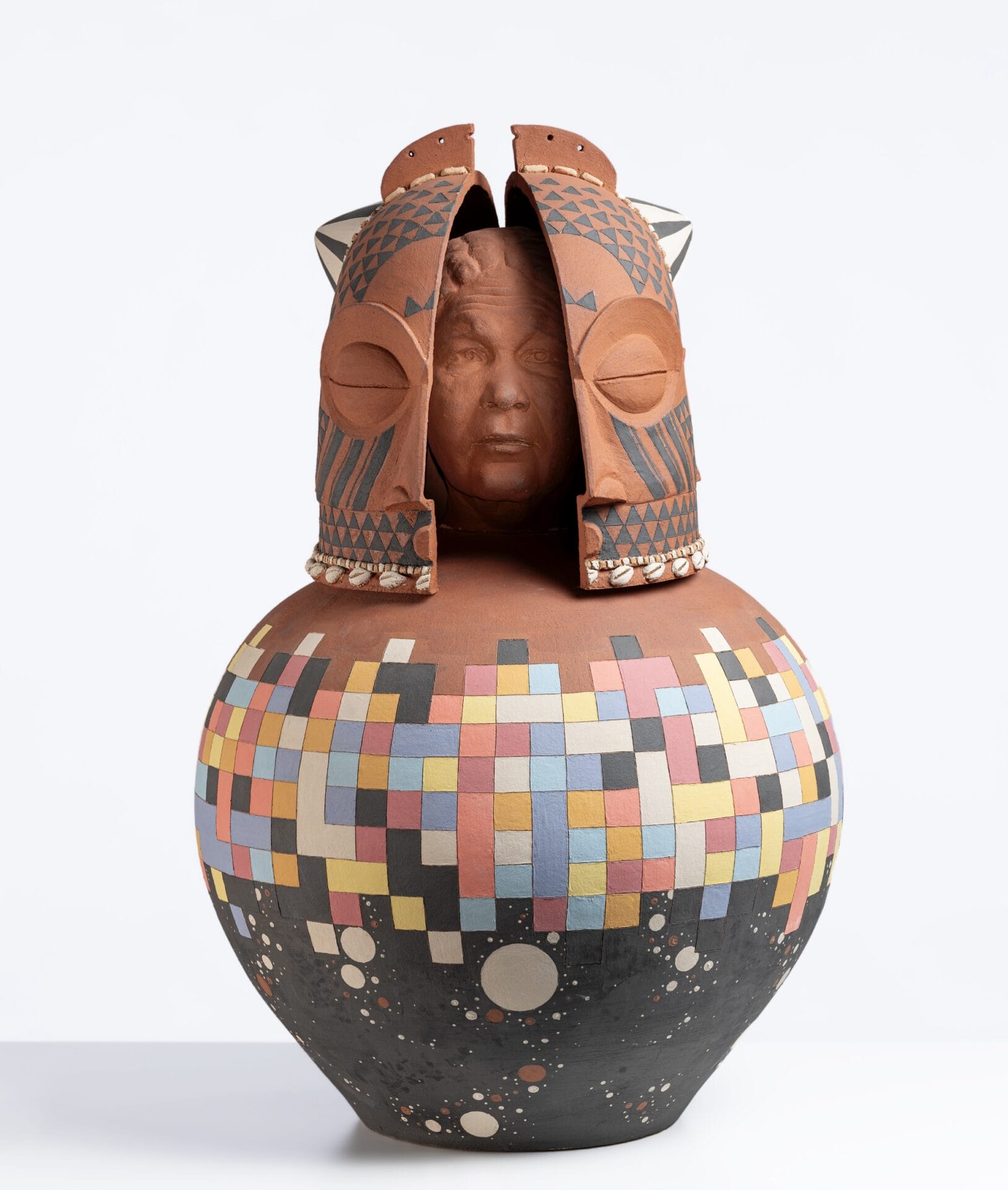 a ceramic sculpture with an abstract-designed vessel on the bottom and the bust of Mary Jane Seacole inside a traditional African mask