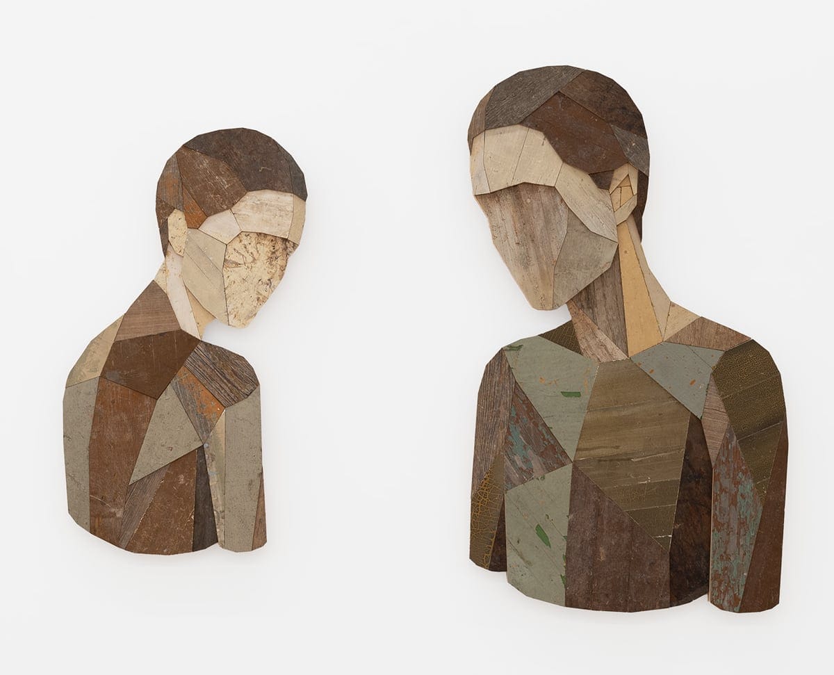 two portrait of faceless figures made of collaged wood