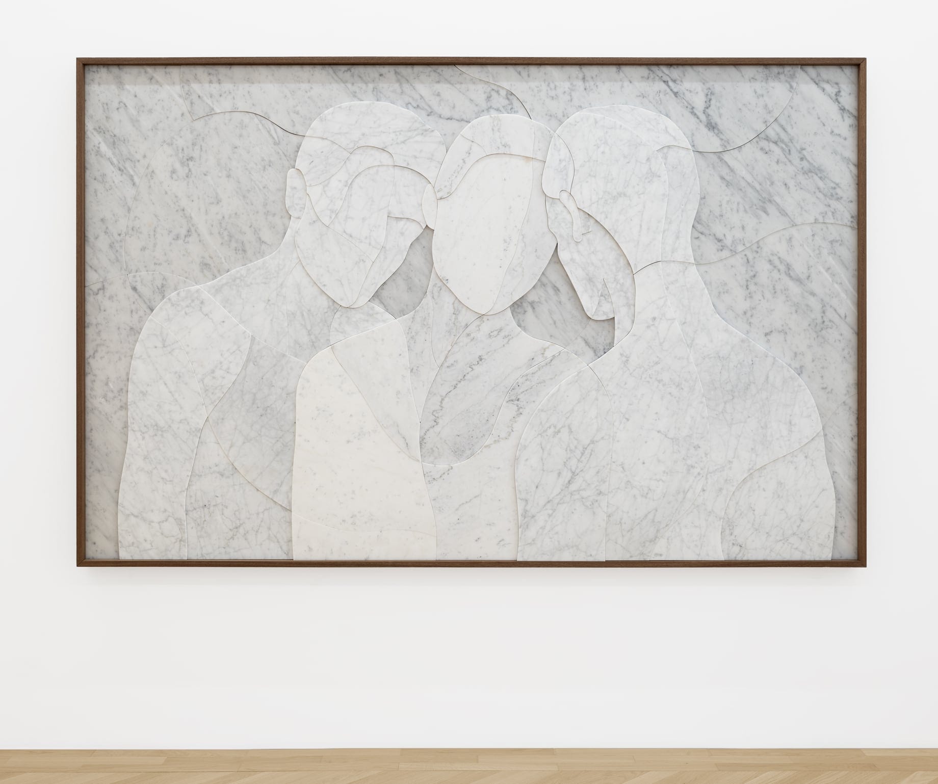 a portrait of three faceless figures made of marble