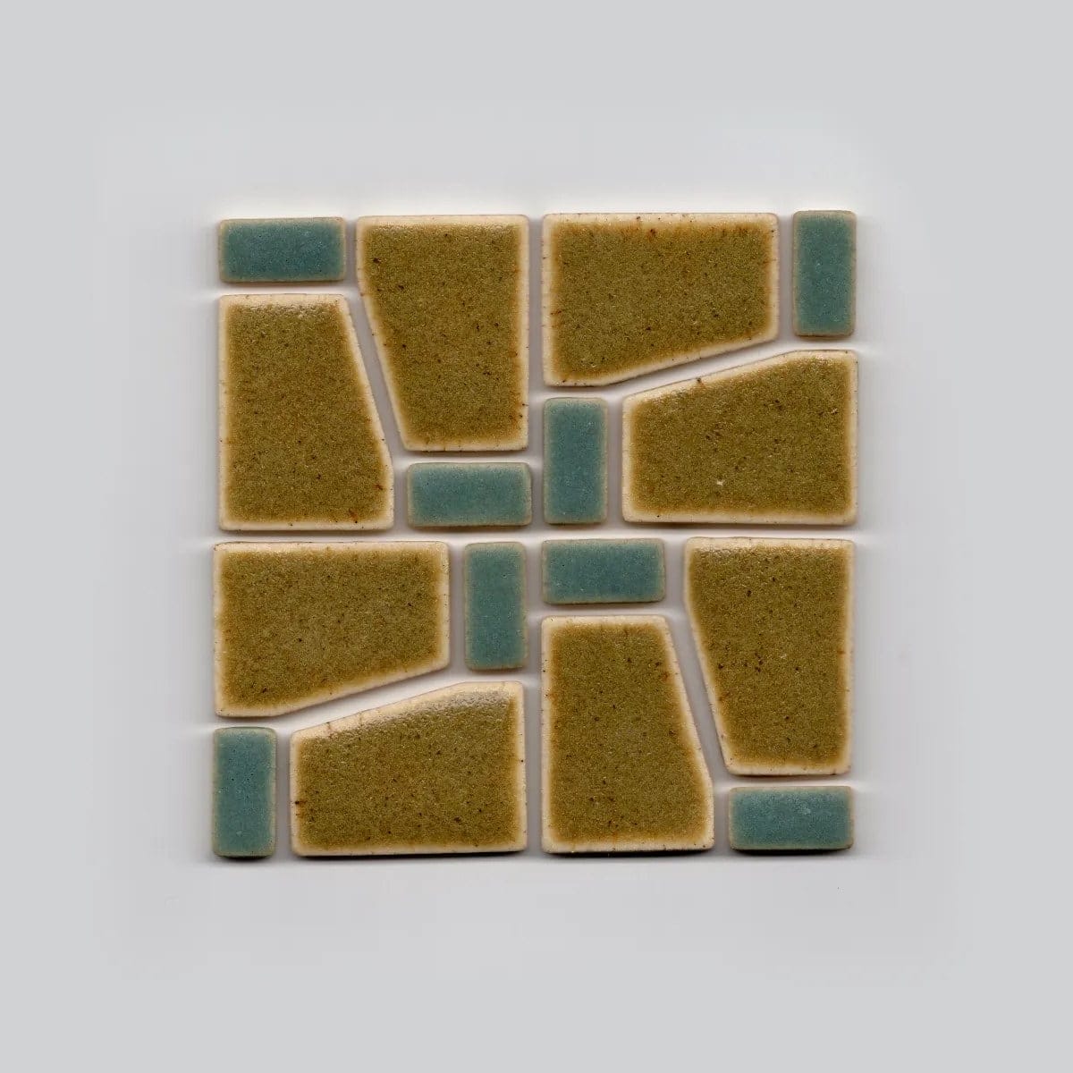 a square tile with brown and blue geometric components nested together
