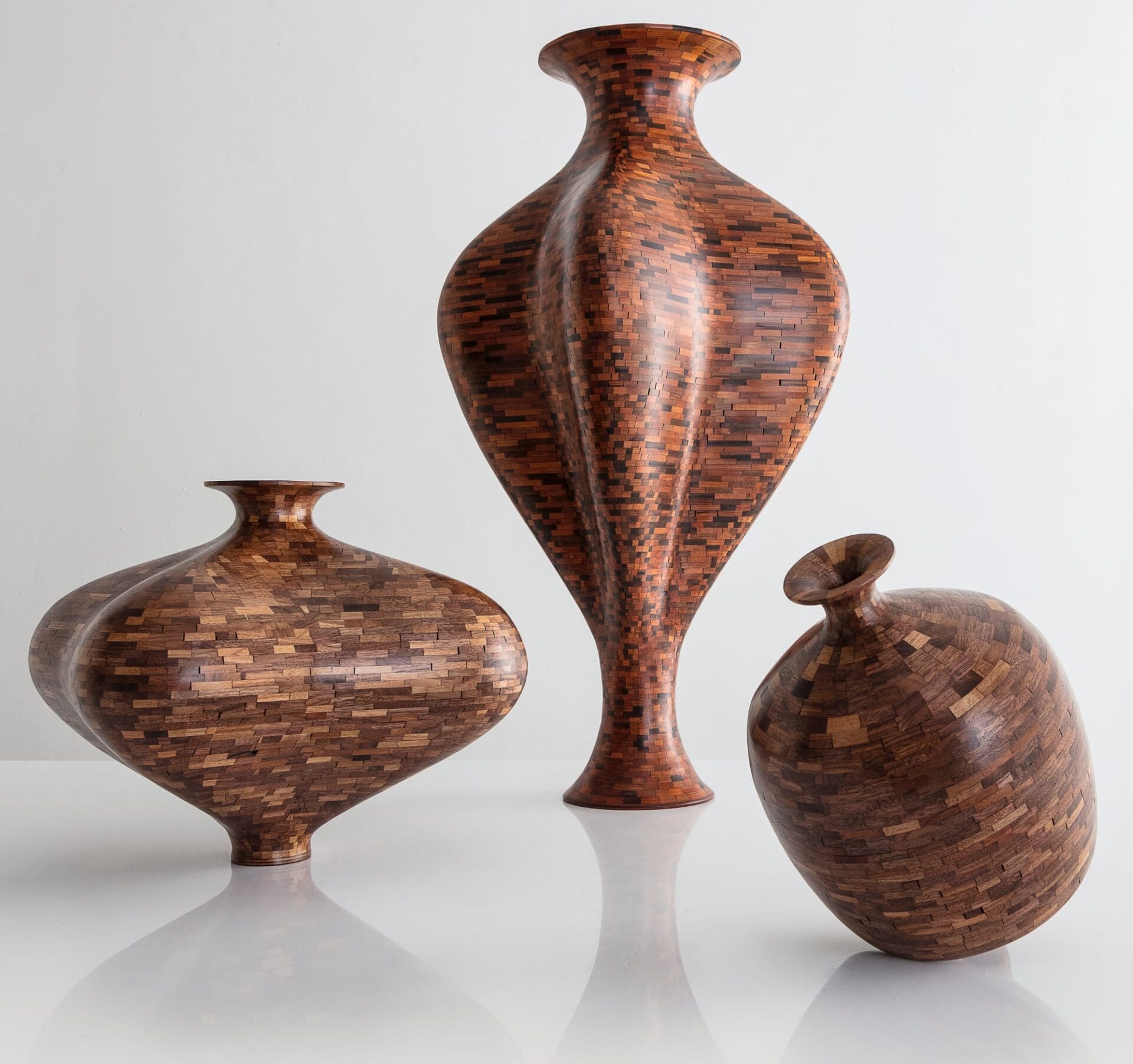 three wooden vessels made of wood components fitted together