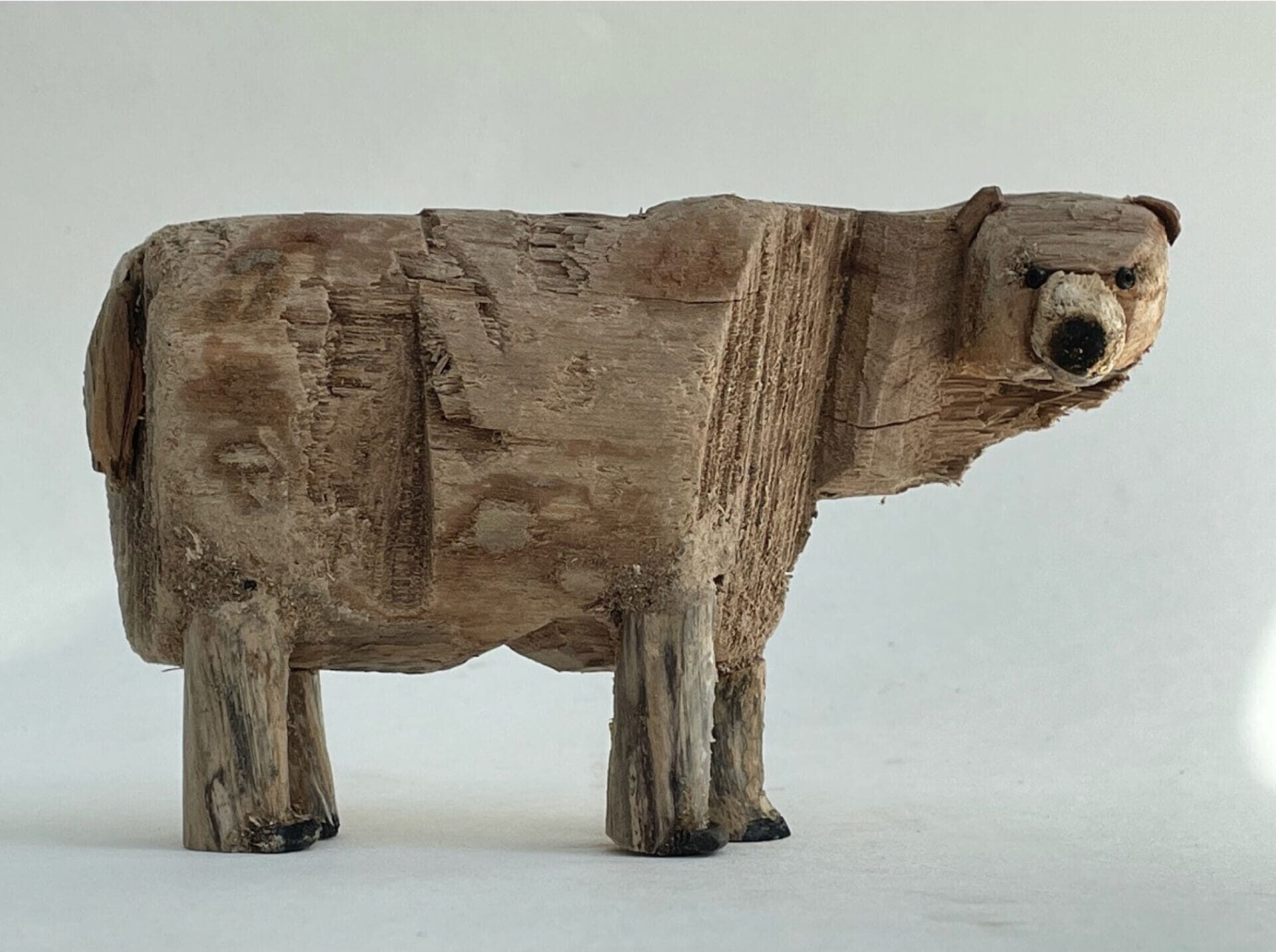 a sculpture of a polar bear made from driftwood