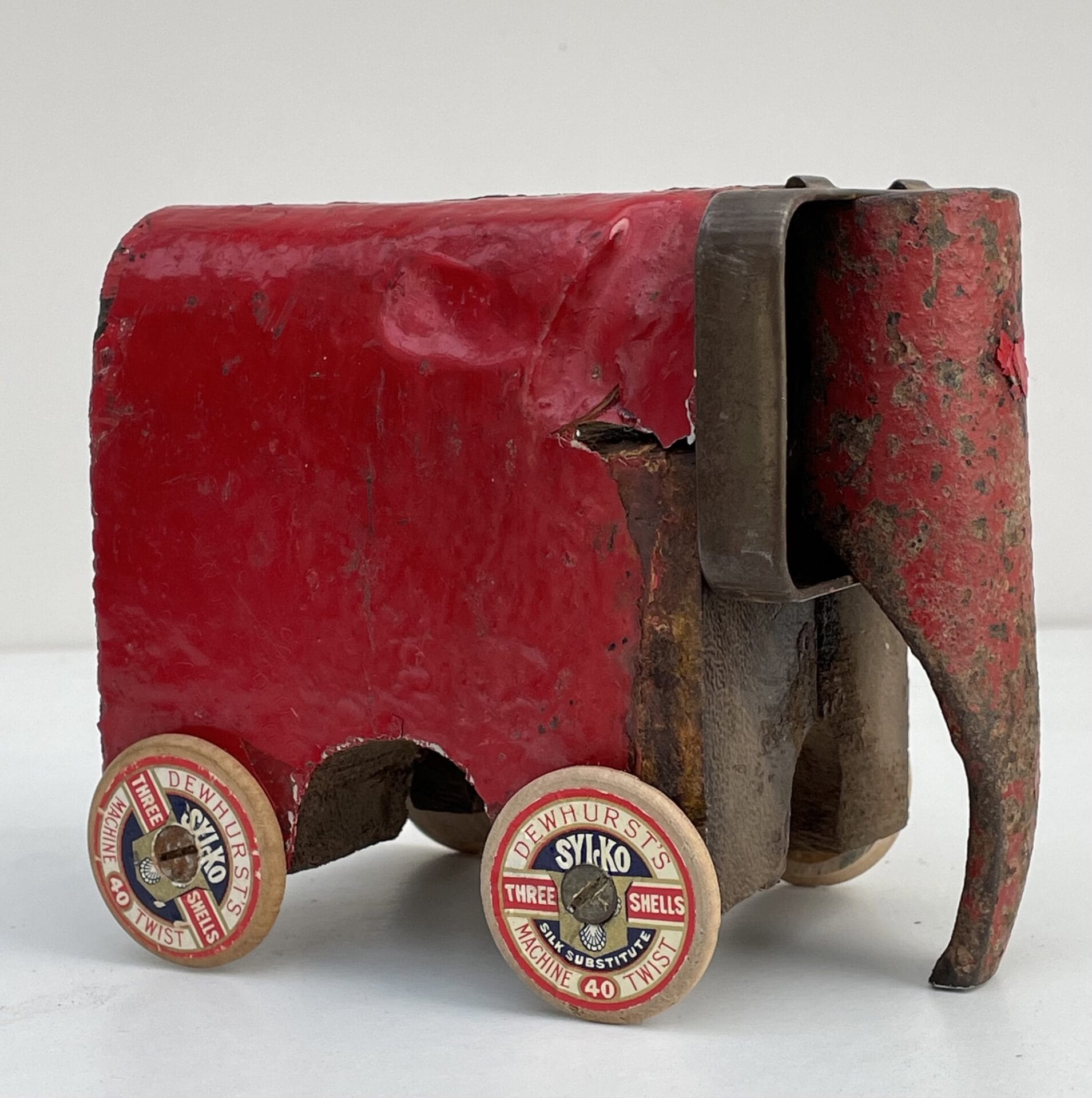 a small sculpture of an elephant made from old metal and some sewing machine elements