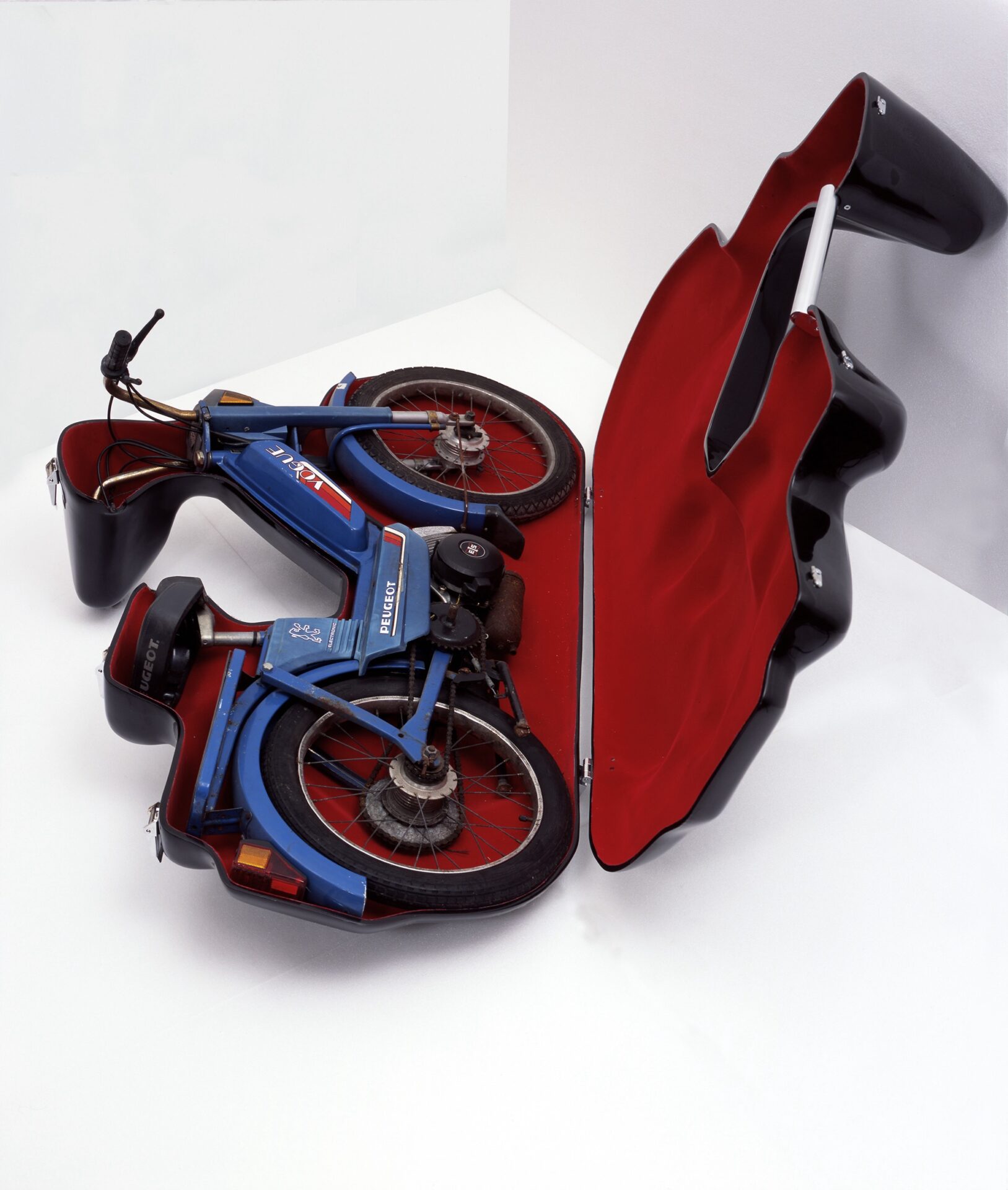 a sculpture of a bespoke carrying case for a blue moped