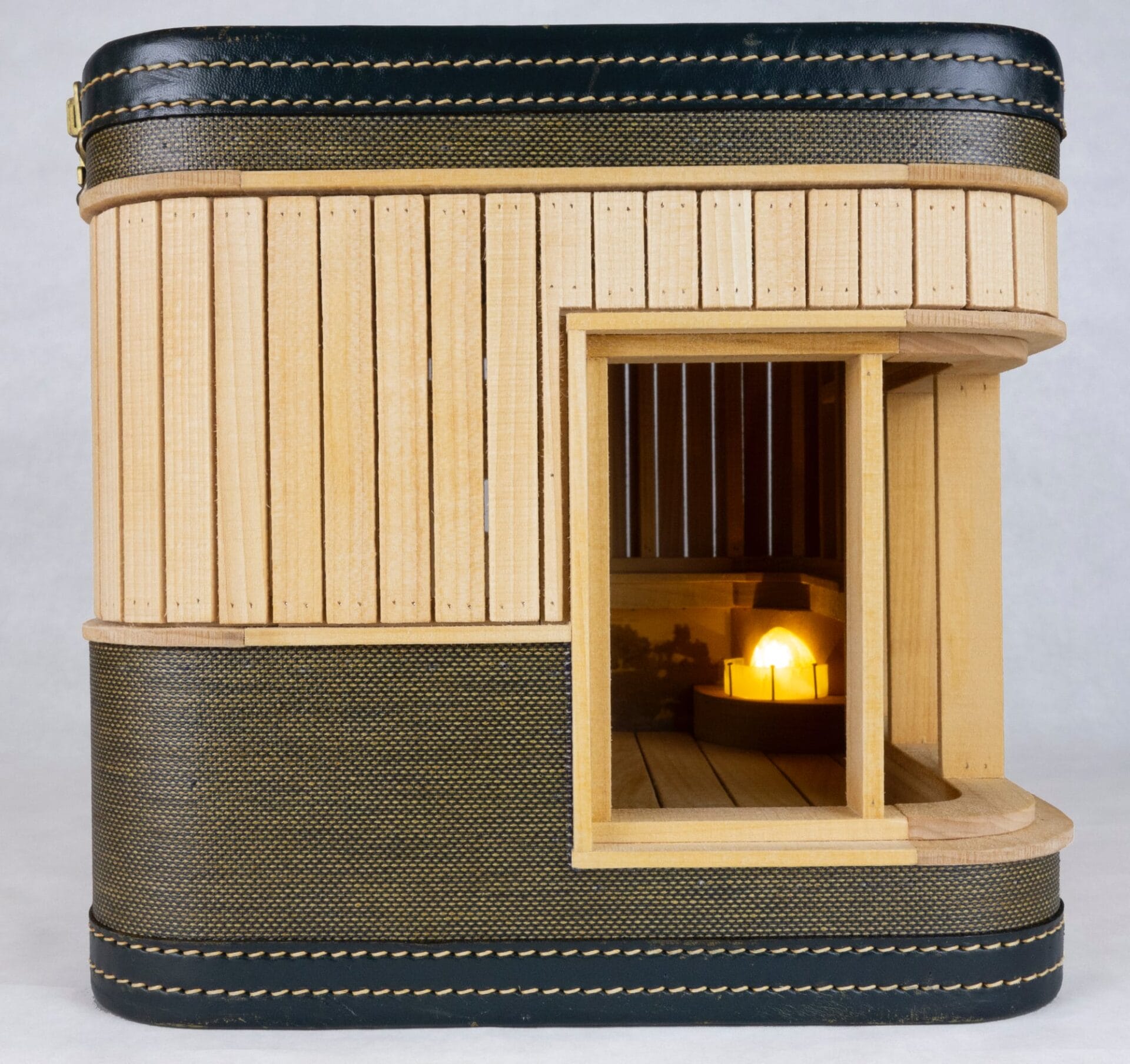 a suitcase with a miniature fireplace inside