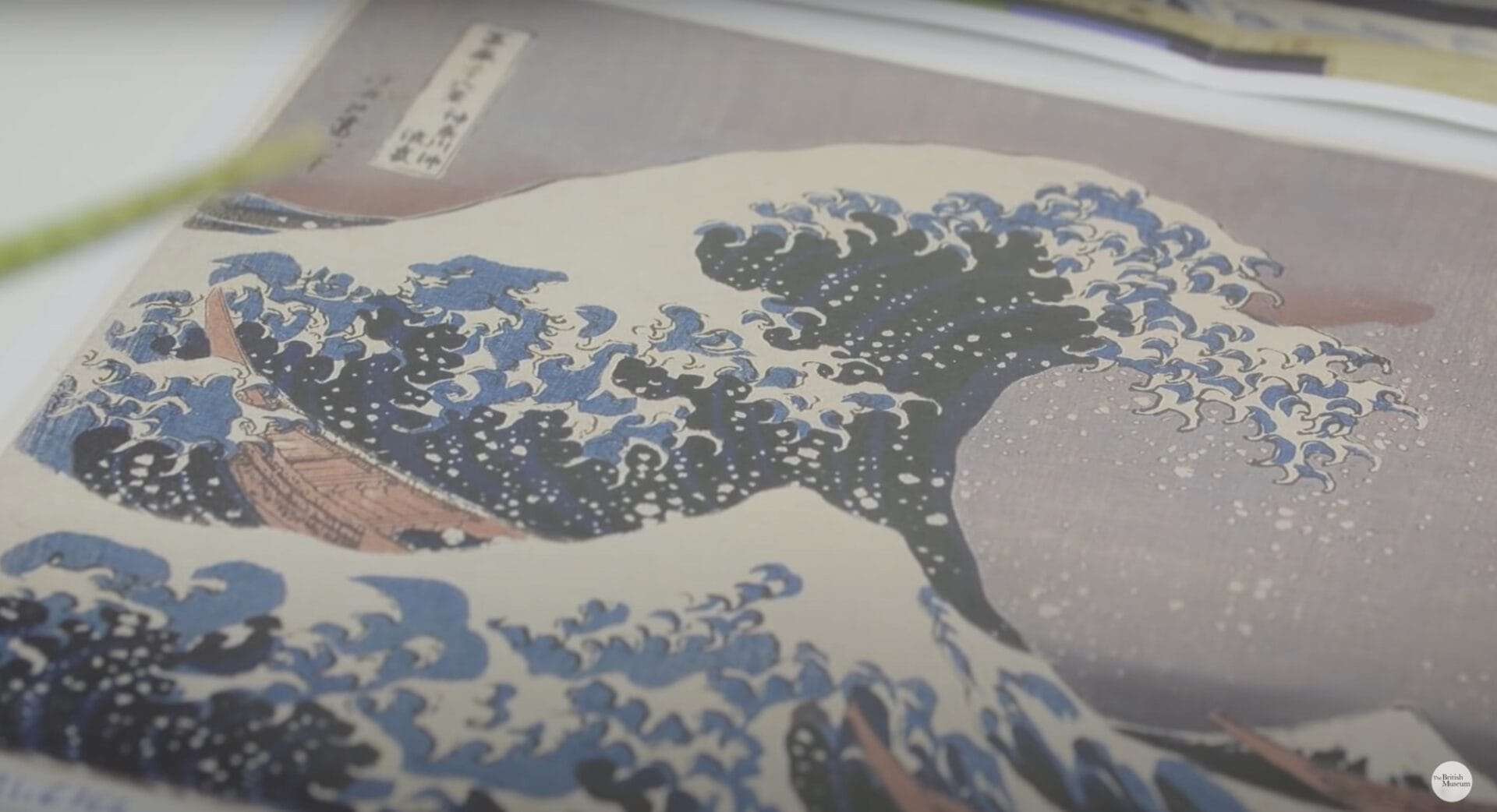 a still from a short documentary about Hokusai's "The Great Wave" print, showing a detail of the wave