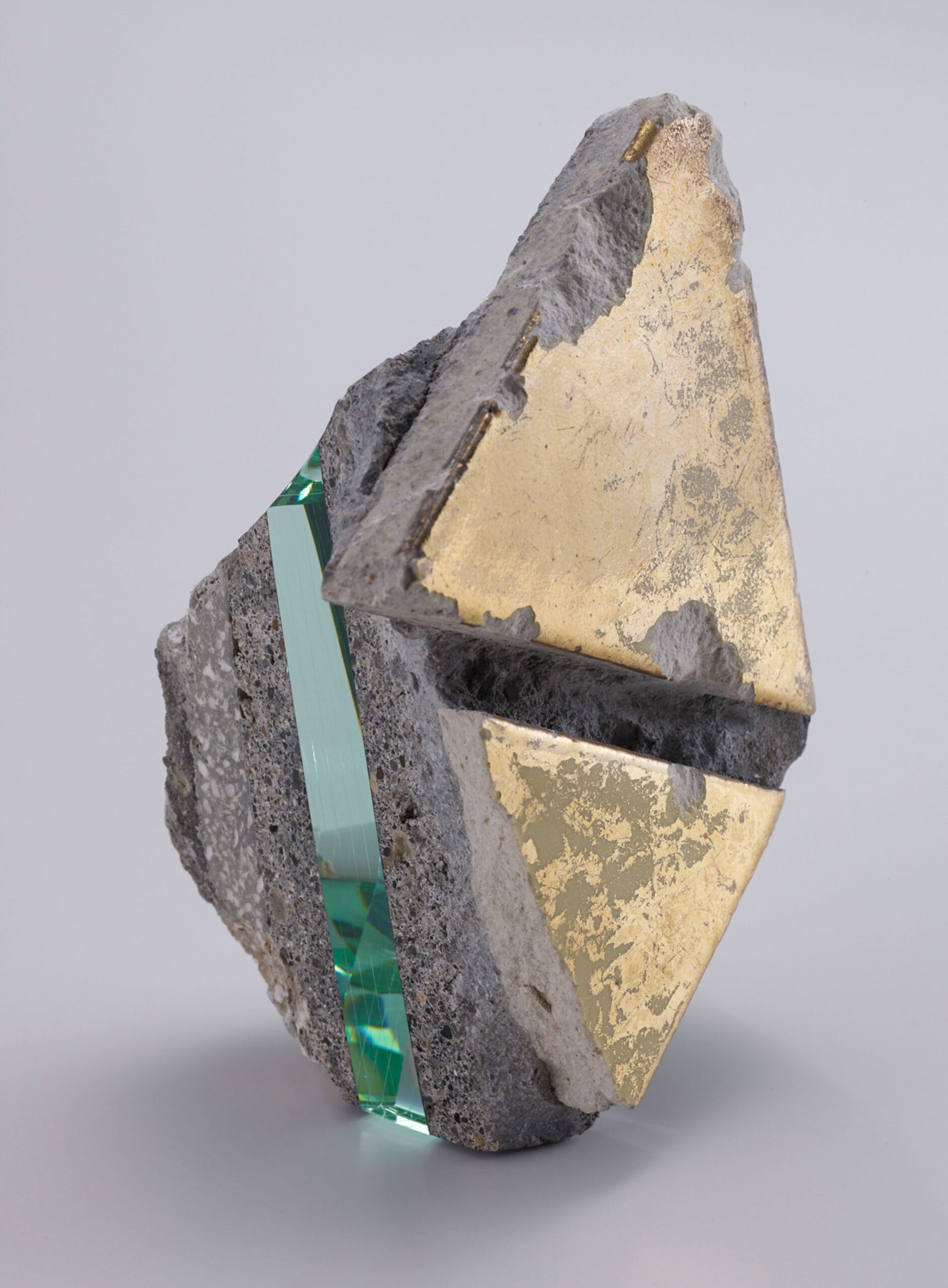 a chunk of debris from a hotel, including an embedded section of layered of aquamarine glass
