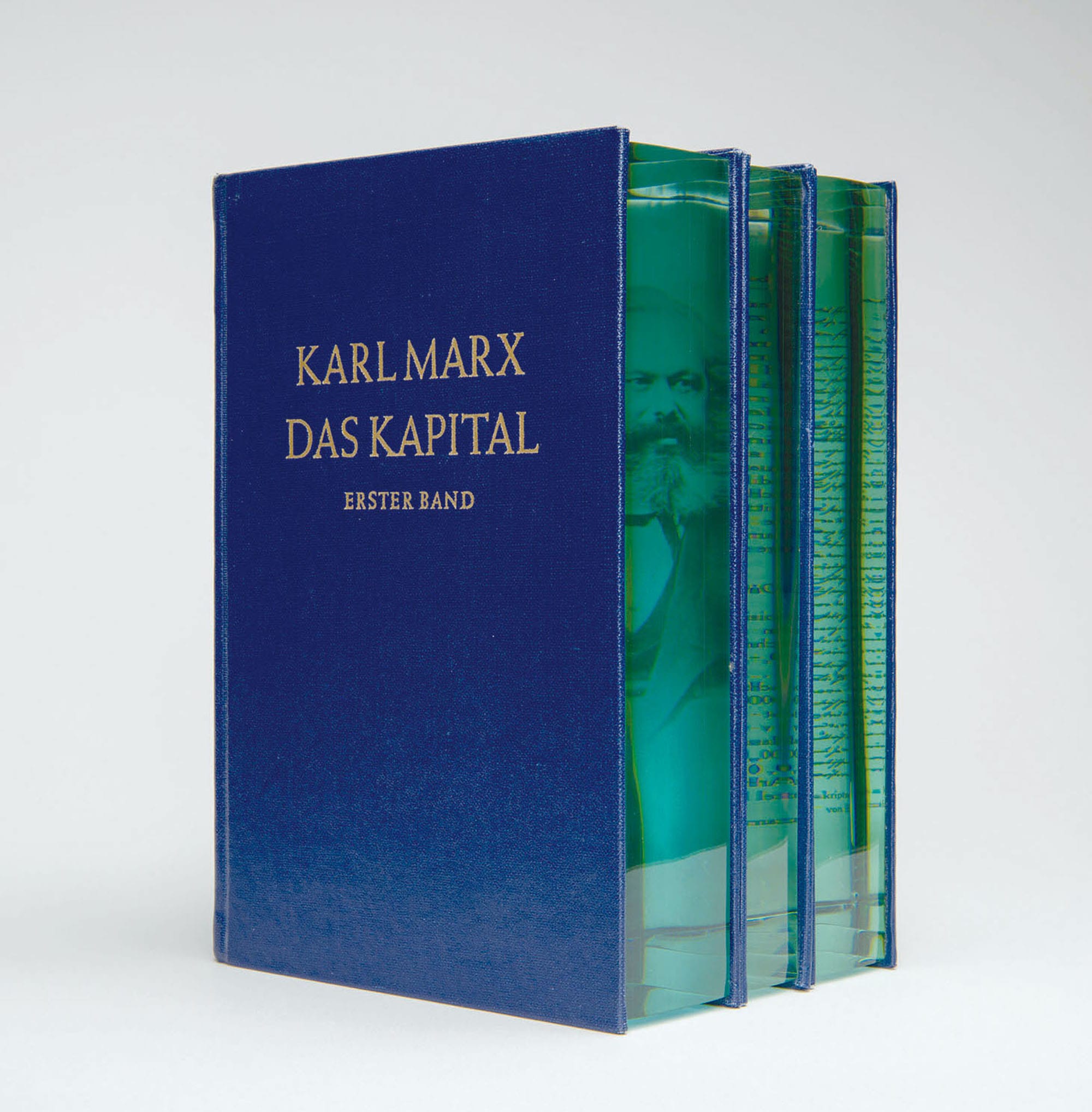 Karl Marx's "Das Kapital" including an embedded section of layered of aquamarine glass