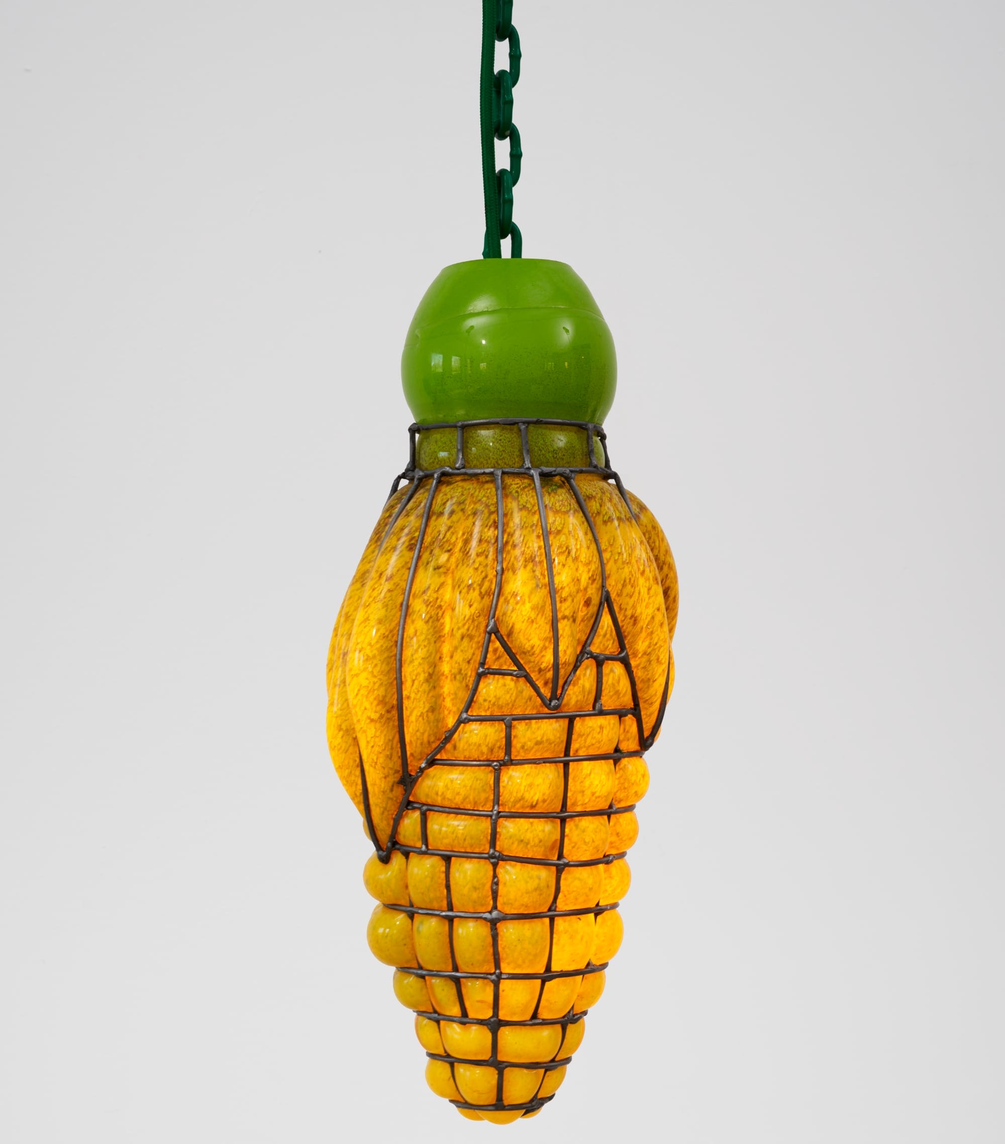 a glass blown pendant lamp hanging from a chain that bubbles inside steel armature and appears like corn