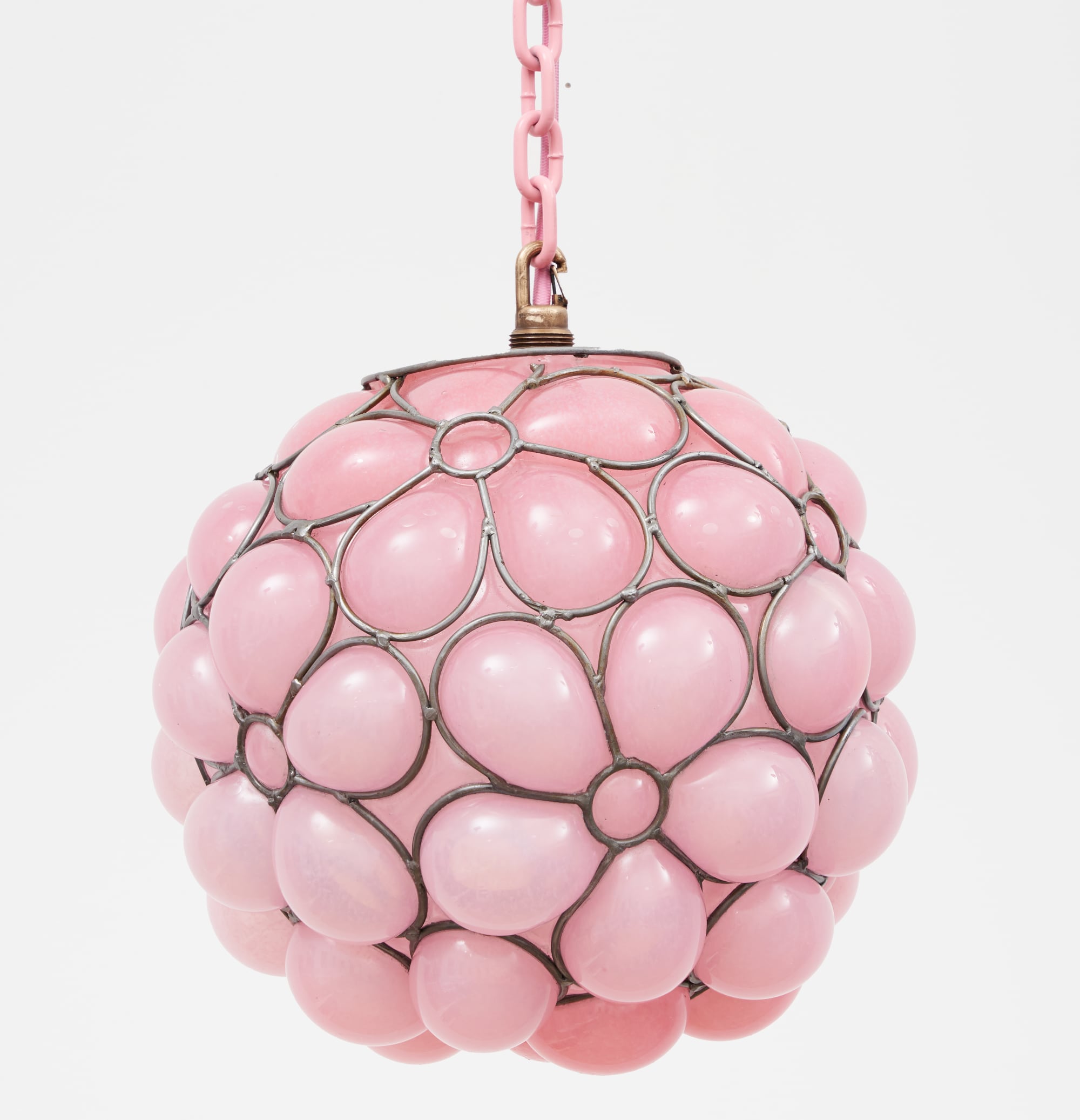 a glass blown pendant lamp hanging from a chain that bubbles inside steel armature and appears like a pink ball of flowers