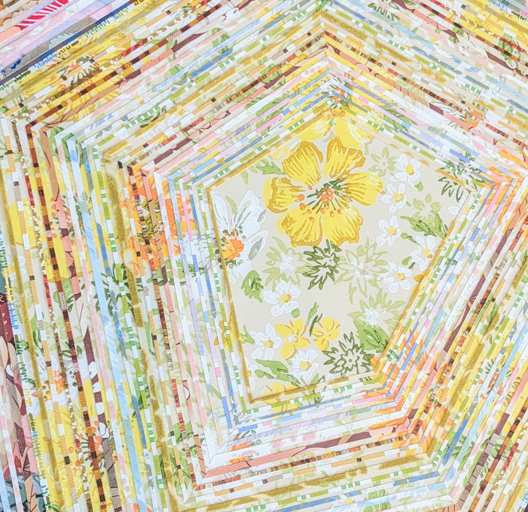 a detail of numerous thin strips of vintage wallpaper in a geometric striped pattern with a yellow flower motif in the center