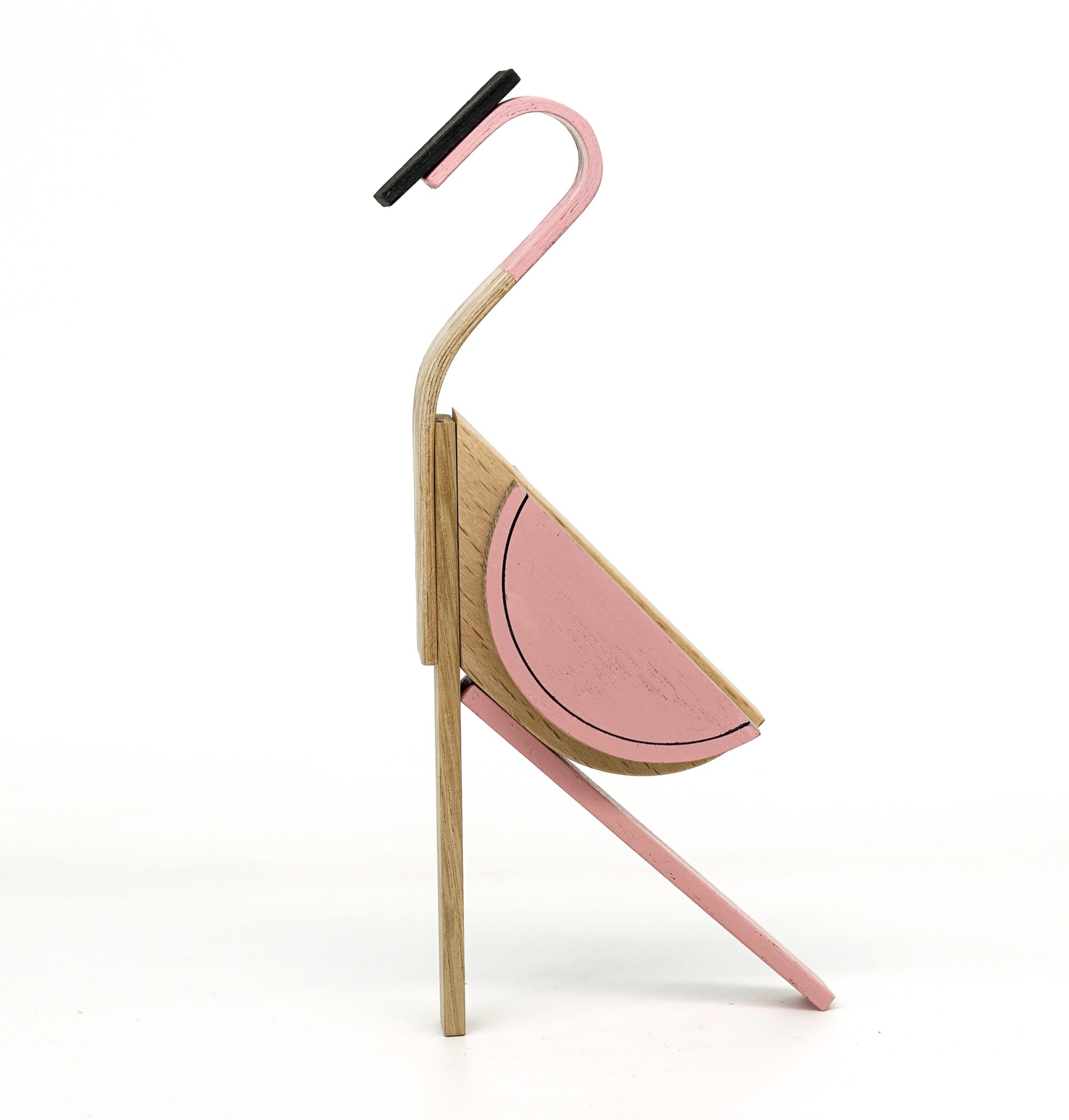 a geometric wooden toy shaped like a modular pink flamingo