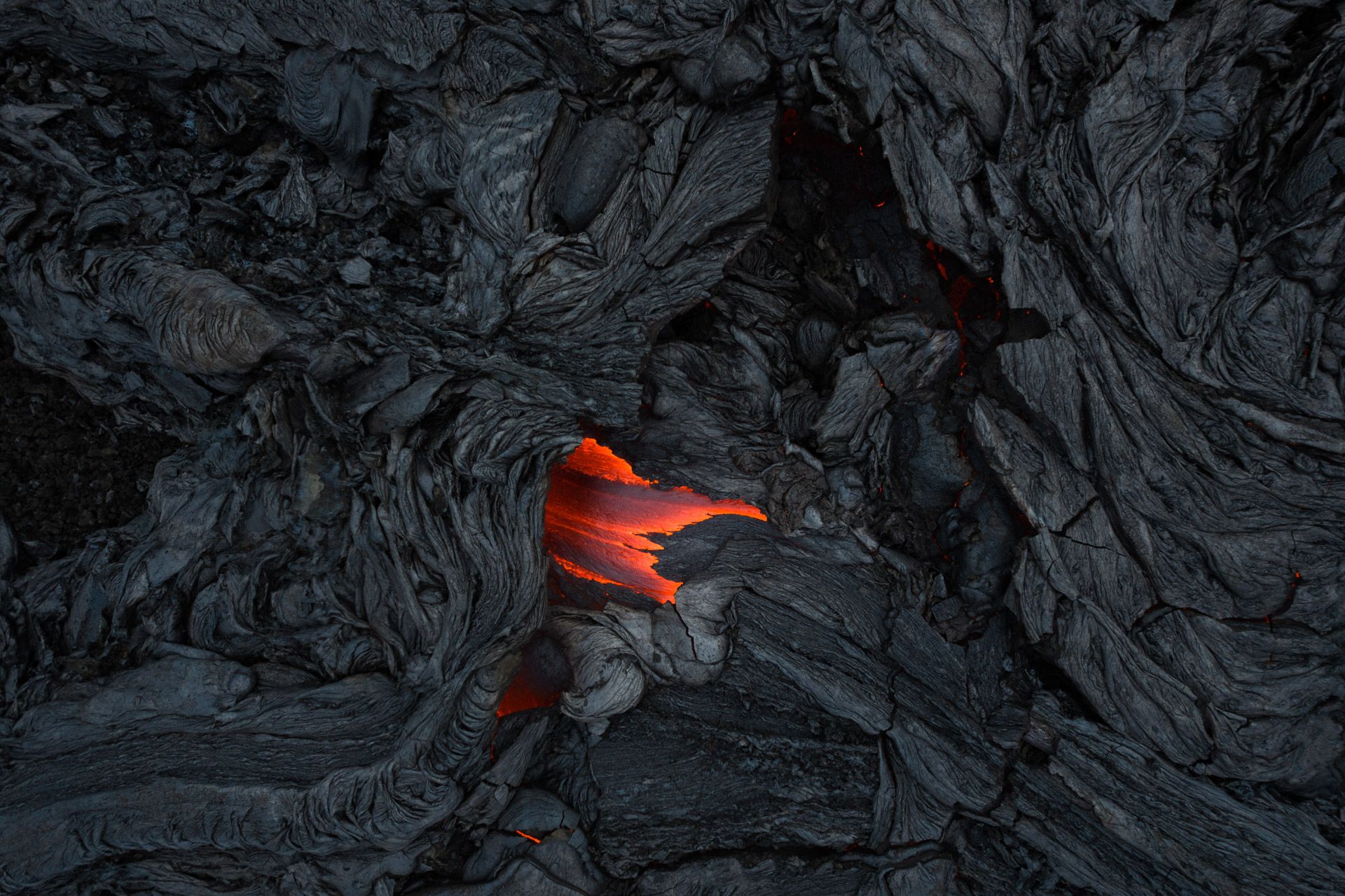 a small strip of red and orange lava in the center of a charred black expanse