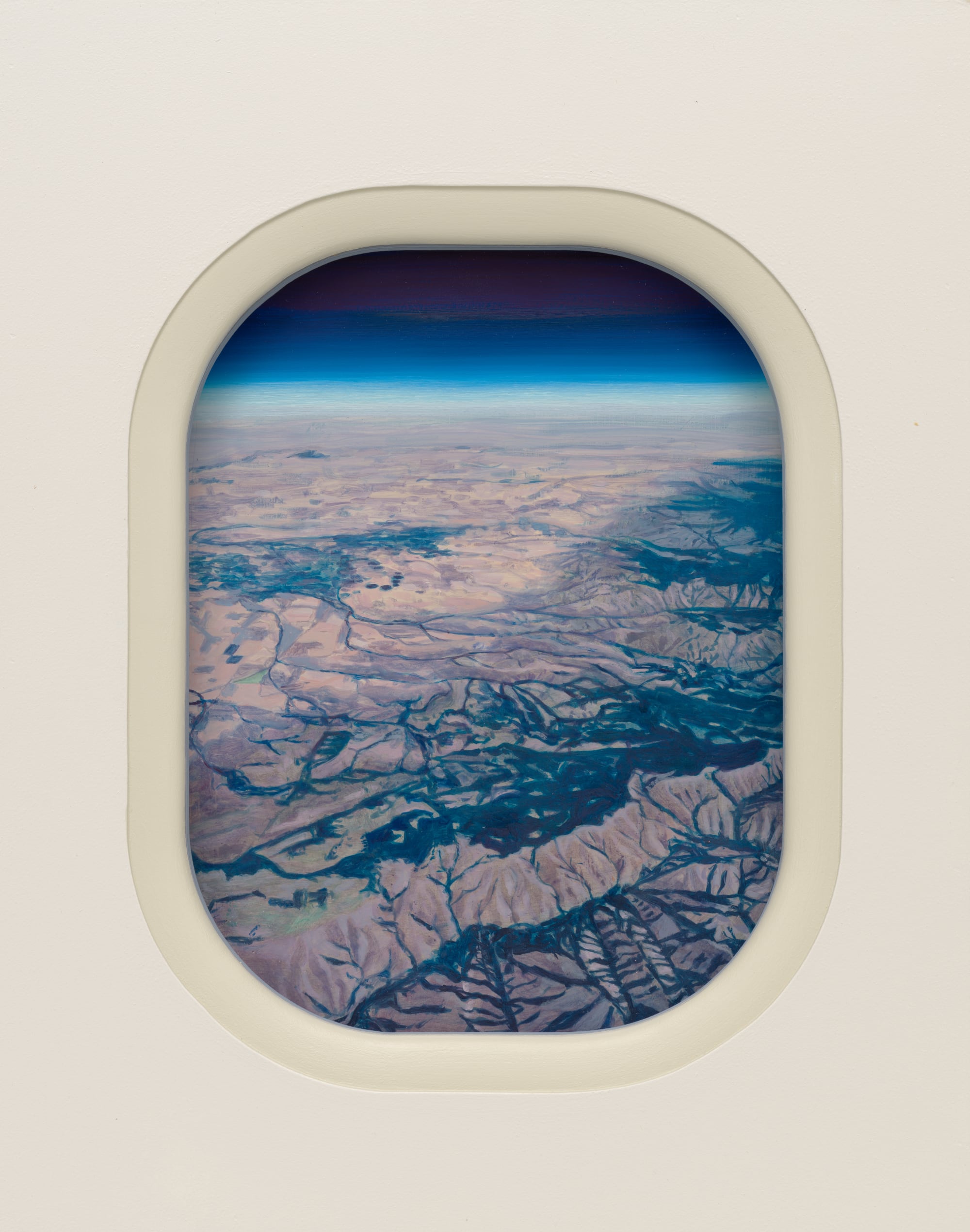 a desert landscape painting through an airplane-like window