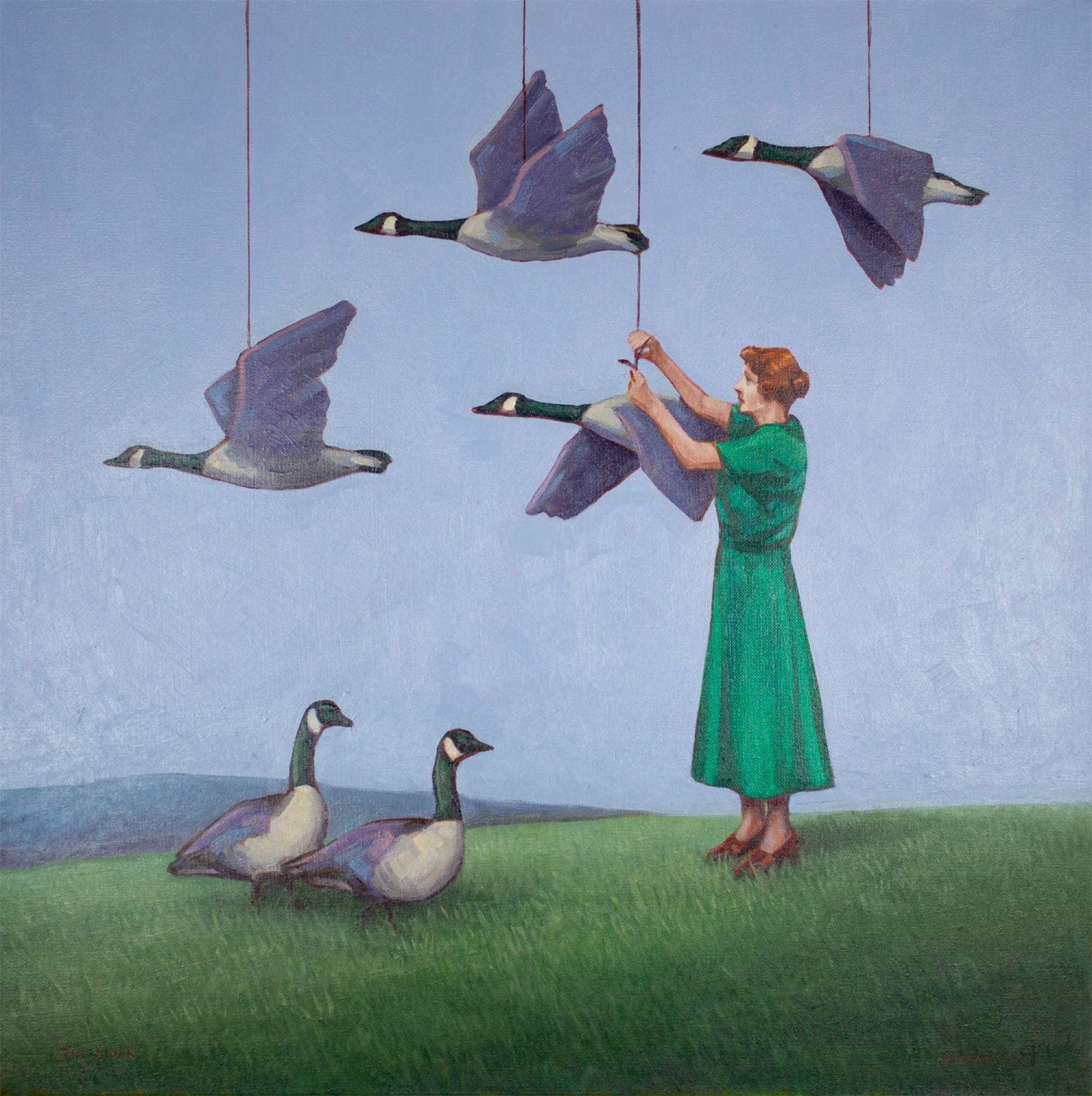 a woman in a green dress hangs geese from strings suspended from the sky