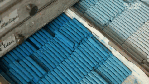 a gif from a short documentary about a pastel maker in France, showing drawers full of numerous pastel sticks in different colors